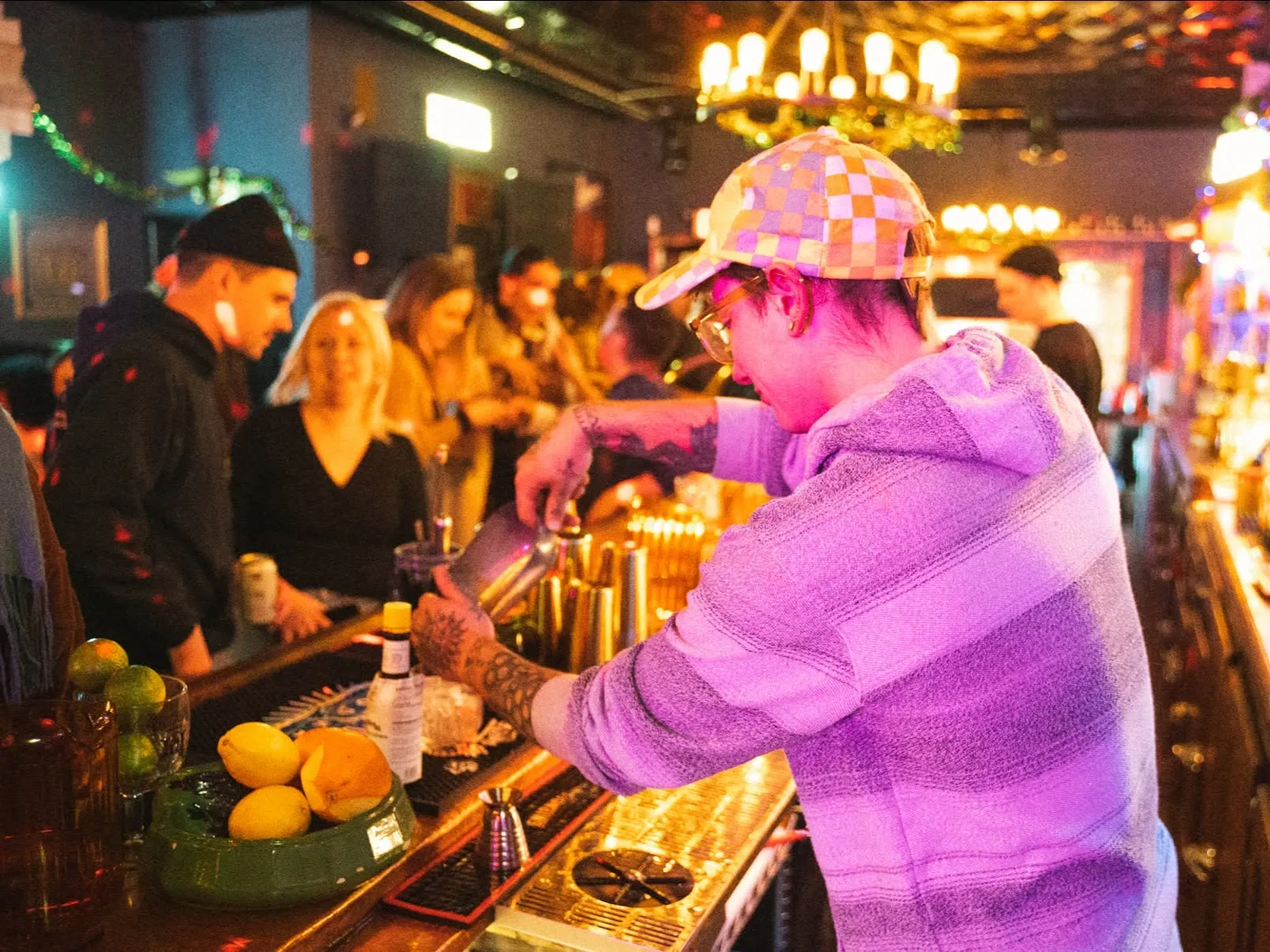 A bartender serving drinks to a crowd